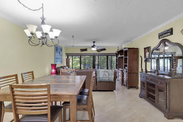 a view of a dining room with furniture a chandelier and wooden floor