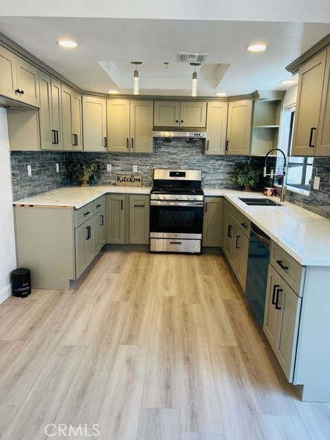 517 North Curtis Avenue, Unit E Alhambra, CA 91801 - Photo 12 of 34 a kitchen with kitchen island granite countertop a sink cabinets and stainless steel appliances