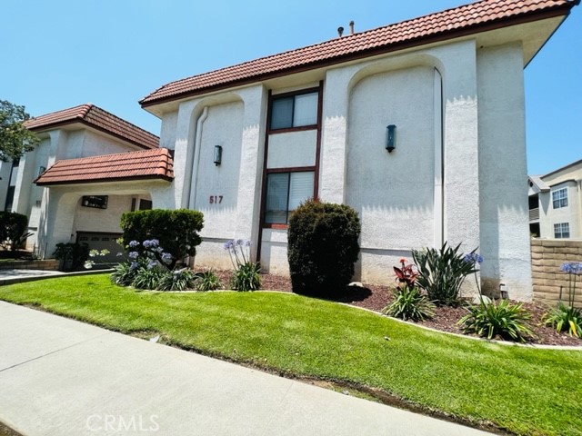 517 North Curtis Avenue, Unit E Alhambra, CA 91801 - Photo 2 of 34 a front view of a house with a yard and garage