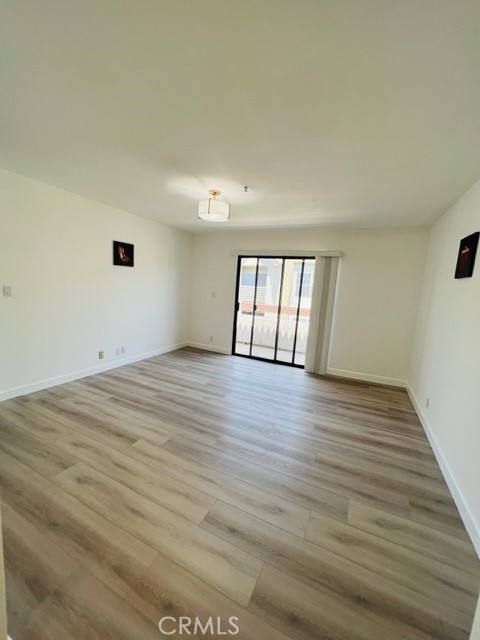517 North Curtis Avenue, Unit E Alhambra, CA 91801 - Photo 23 of 34 a view of an empty room with wooden floor and a window