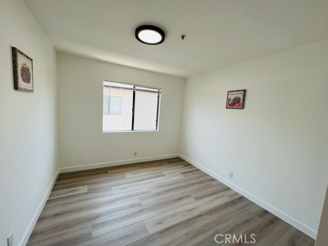 517 North Curtis Avenue, Unit E Alhambra, CA 91801 - Photo 28 of 34 an empty room with wooden floor and windows