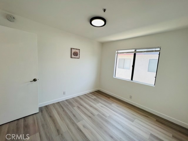 517 North Curtis Avenue, Unit E Alhambra, CA 91801 - Photo 29 of 34 an empty room with a window and ceiling fan