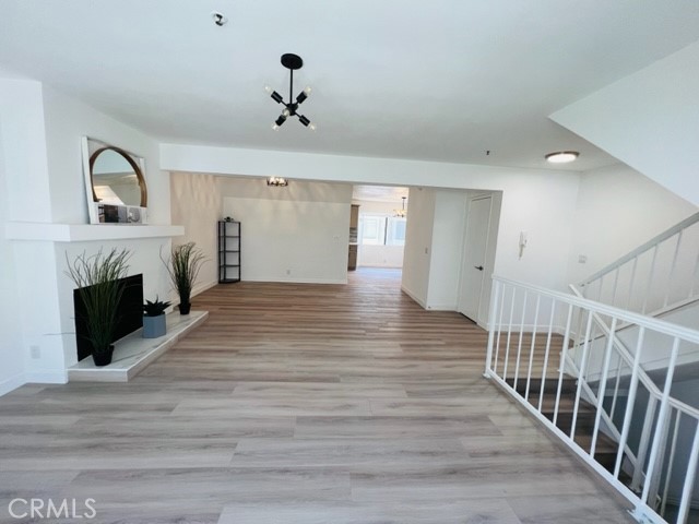 517 North Curtis Avenue, Unit E Alhambra, CA 91801 - Photo 6 of 34 a view of a livingroom with wooden floor and a fireplace