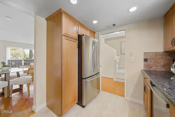 a dining room with furniture and wooden floor