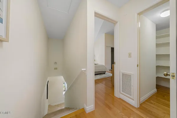 a bedroom with a bed and a potted plant