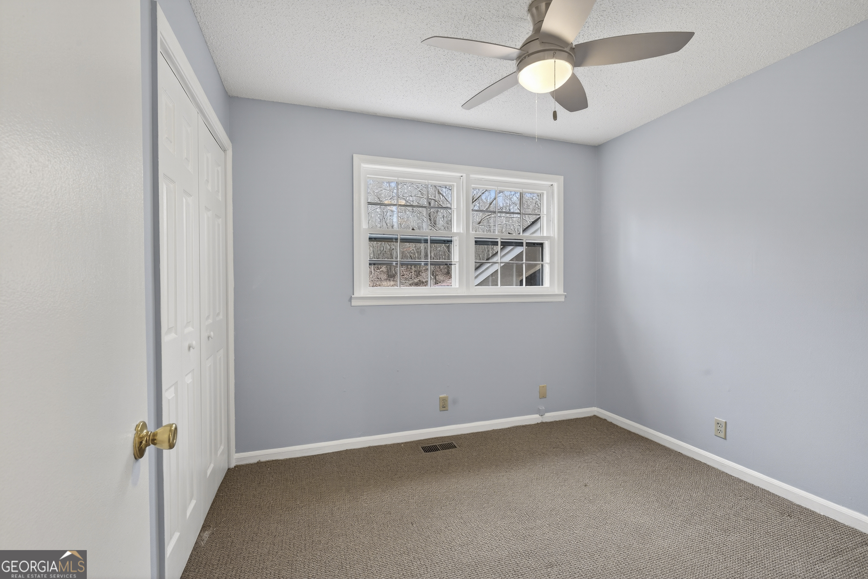 149 Forest Hill Road Southwest Milledgeville, GA 31061 - Photo 15 of 29 an empty room with a window and a fan