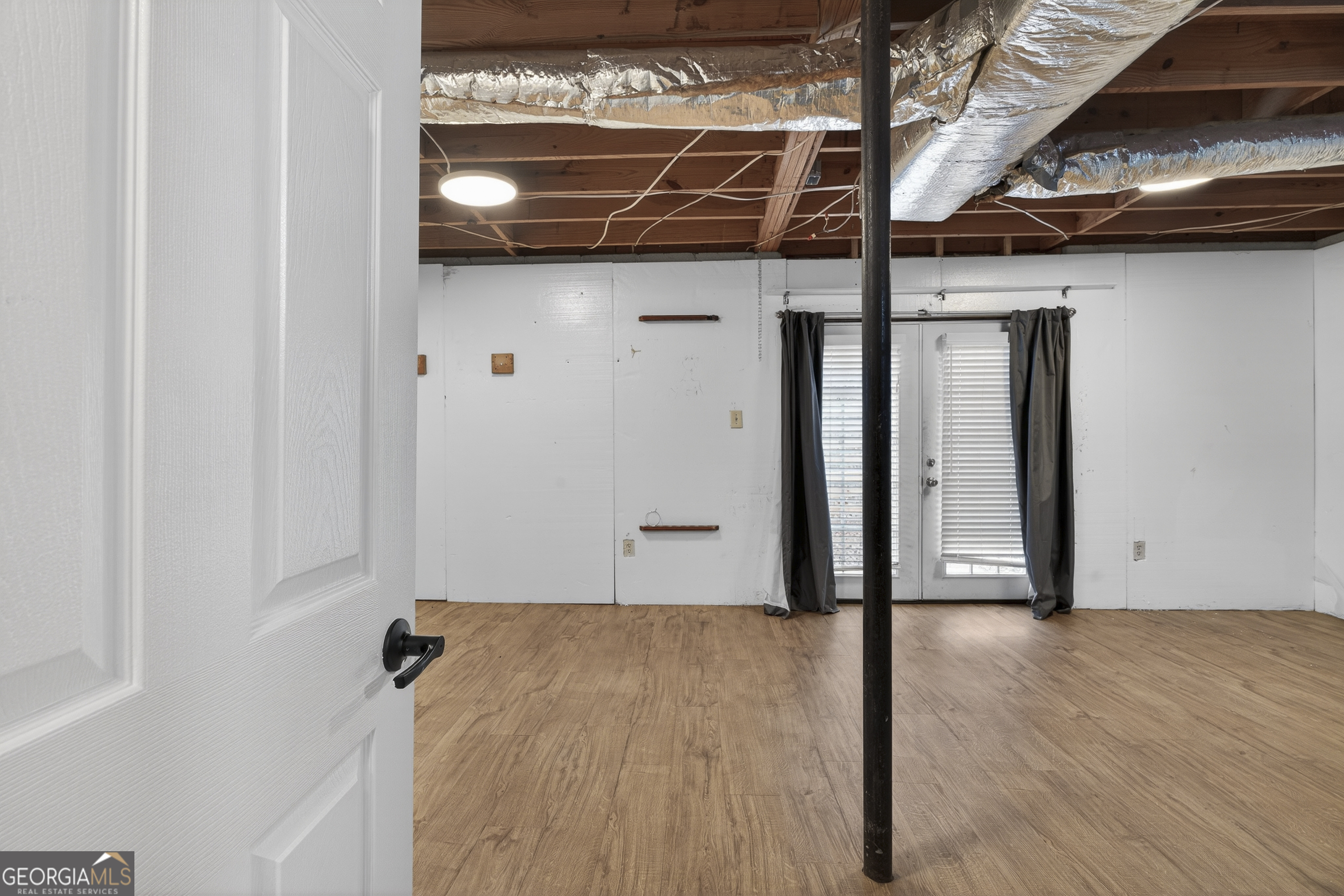 149 Forest Hill Road Southwest Milledgeville, GA 31061 - Photo 17 of 29 a view of a room with wooden walls
