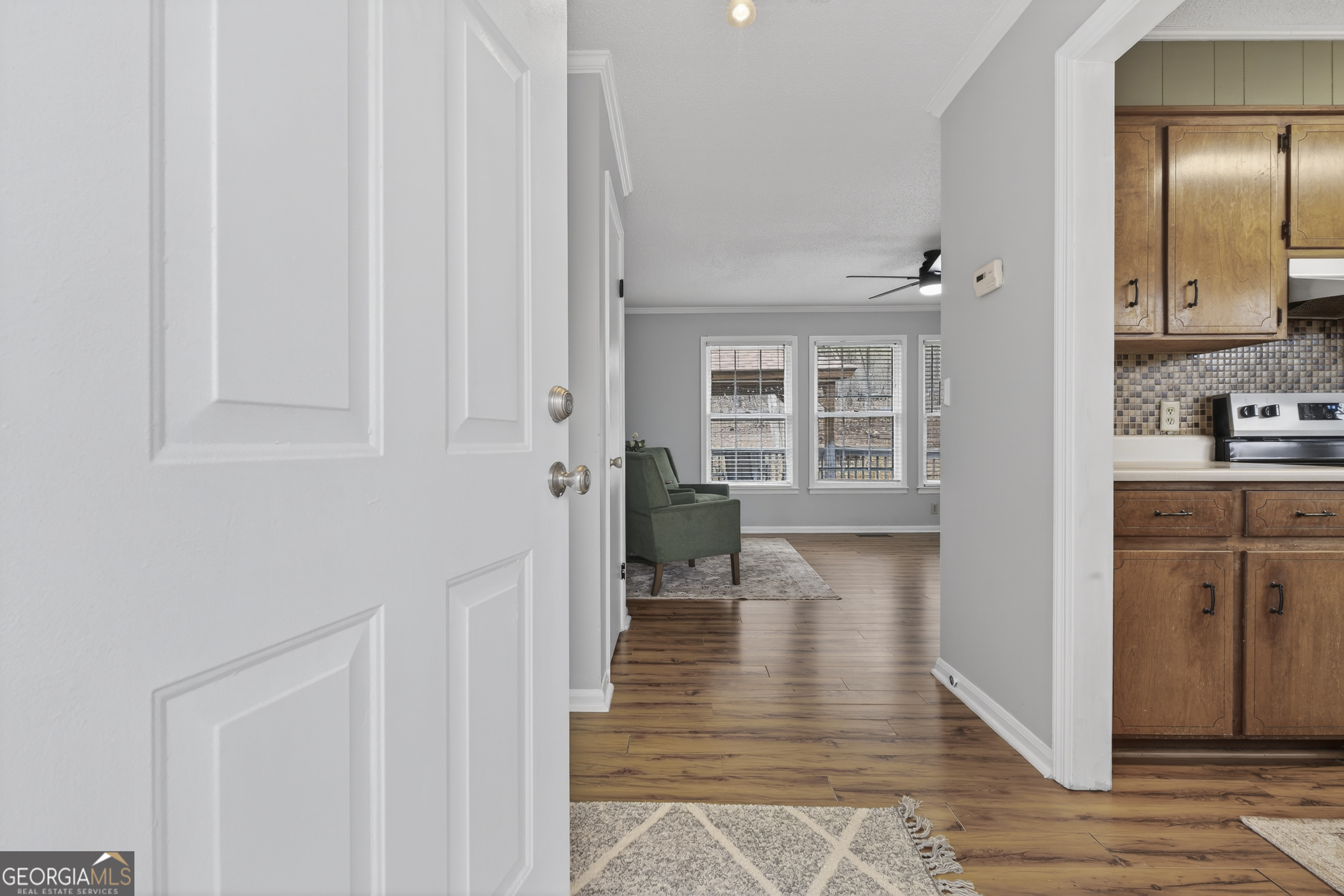 149 Forest Hill Road Southwest Milledgeville, GA 31061 - Photo 3 of 29 a view of a hallway with wooden floor windows and livingroom