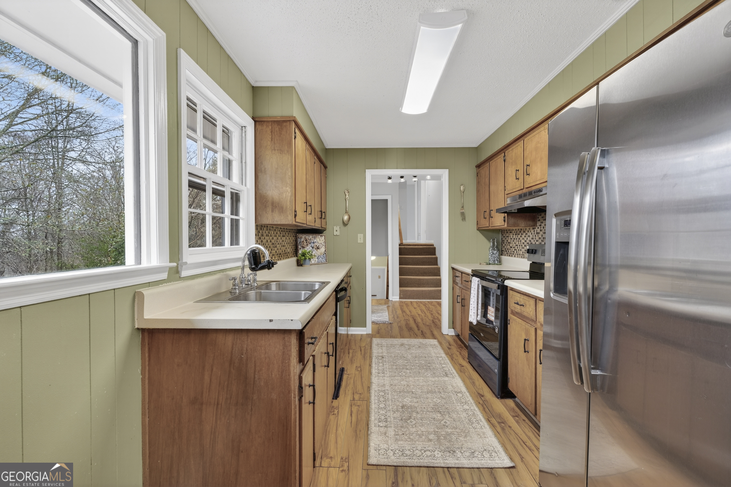 149 Forest Hill Road Southwest Milledgeville, GA 31061 - Photo 8 of 29 a kitchen with kitchen island a sink stove and refrigerator