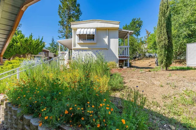 a view of backyard of house with green space