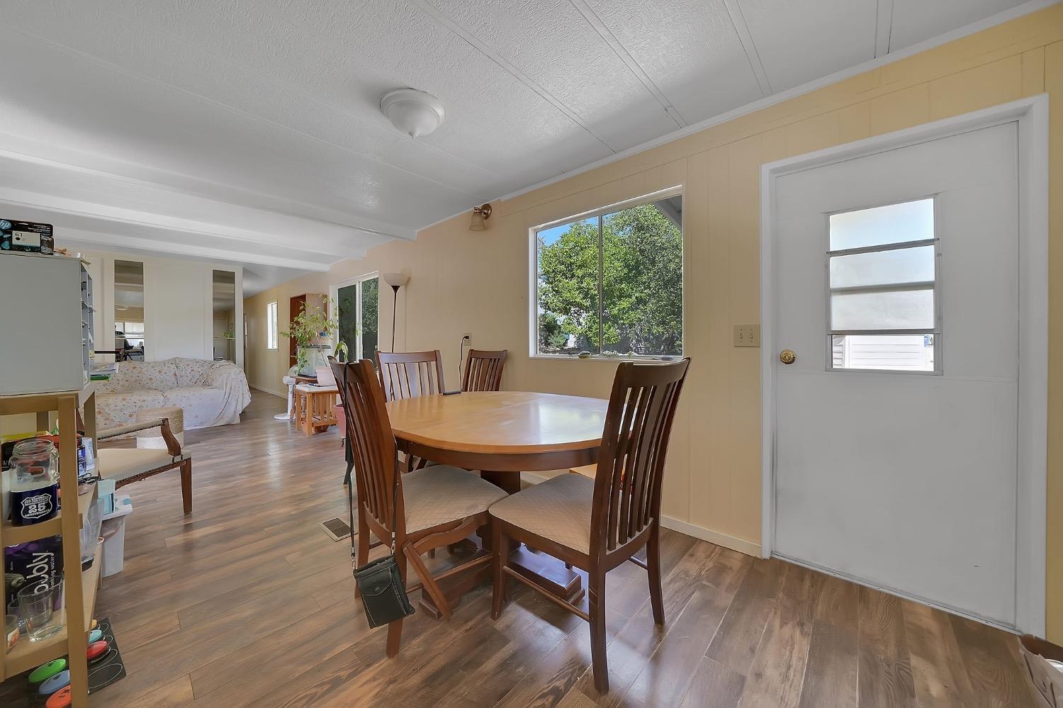 150 Clinton Road, Unit 38 Jackson, CA 95642 - Photo 11 of 18 a view of a dining room with furniture and wooden floor