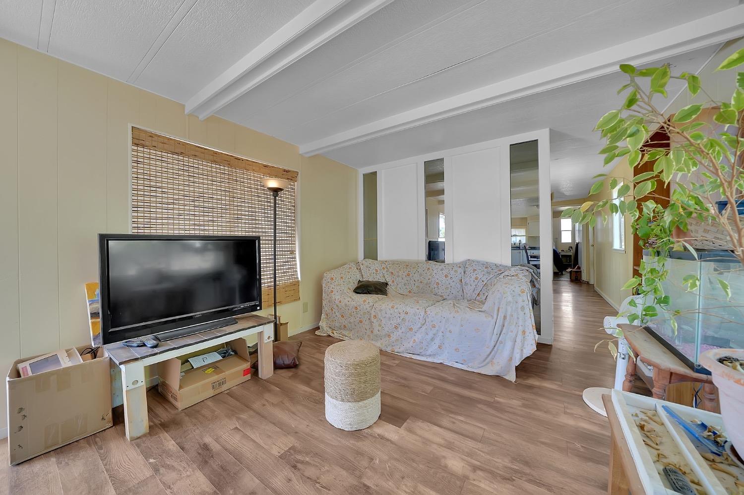 150 Clinton Road, Unit 38 Jackson, CA 95642 - Photo 13 of 18 a living room with furniture and a flat screen tv