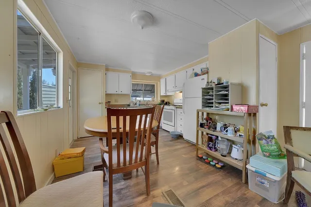 a view of a dining room with furniture and a book shelf