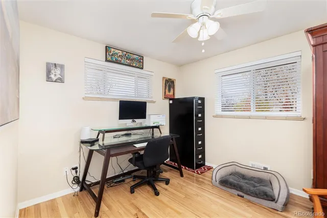 a view of a workspace with furniture and a window