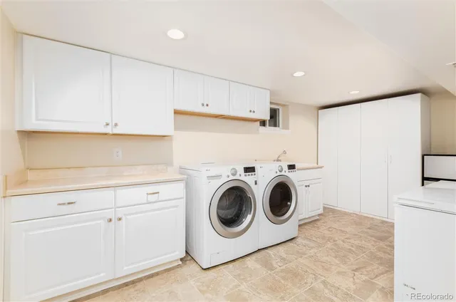 a utility room with sink dryer and washer