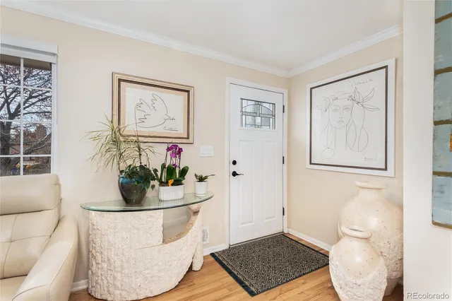 a living room with furniture and flowers