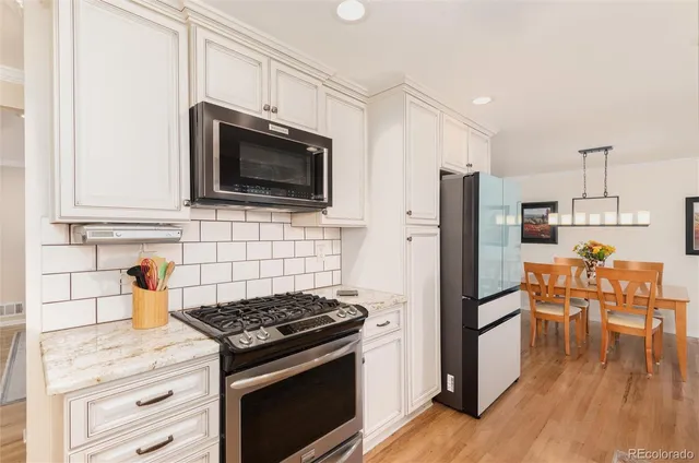 a kitchen with stainless steel appliances a stove a microwave and a refrigerator