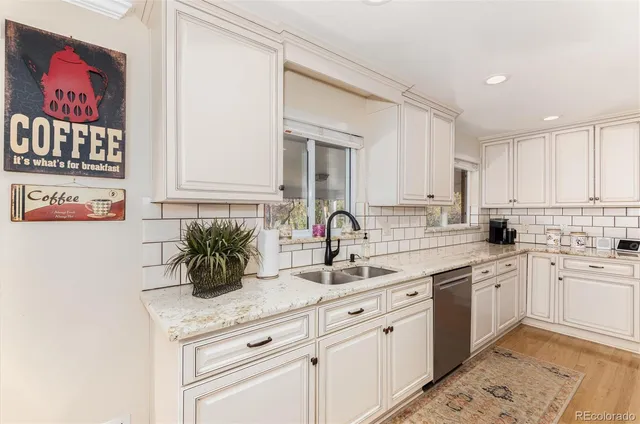 a kitchen with white cabinets and a sink