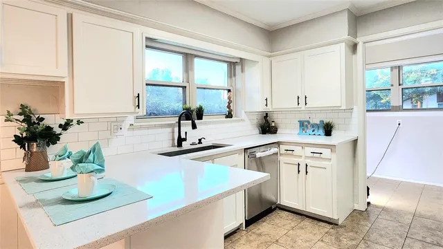 a kitchen with sink refrigerator and window