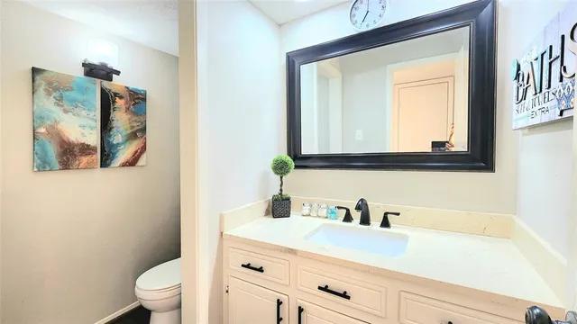 a bathroom with a sink a toilet and a mirror