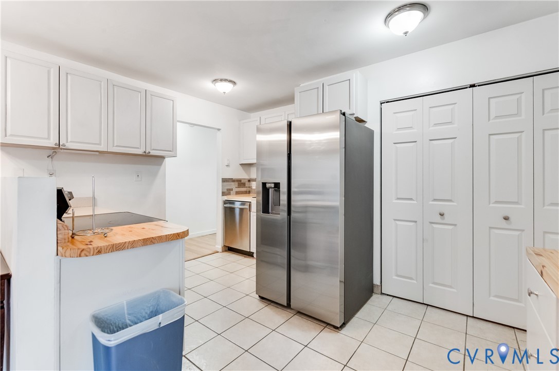 5724 Linda Road Sandston, VA 23150 - Photo 13 of 35 a kitchen with stainless steel appliances granite countertop a refrigerator a sink and white cabinets