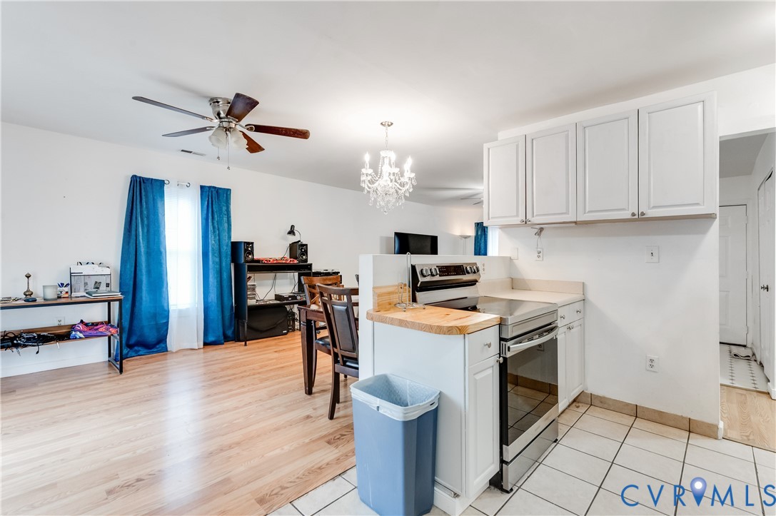 5724 Linda Road Sandston, VA 23150 - Photo 16 of 35 a open kitchen with stainless steel appliances granite countertop a stove top oven a sink dishwasher and a refrigerator with wooden floor