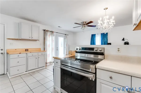a kitchen with a stove cabinets and window