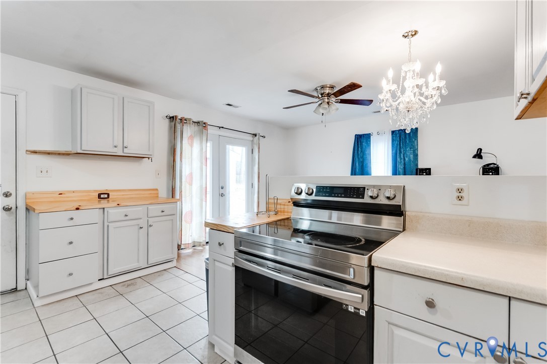 5724 Linda Road Sandston, VA 23150 - Photo 17 of 35 a kitchen with a stove cabinets and window