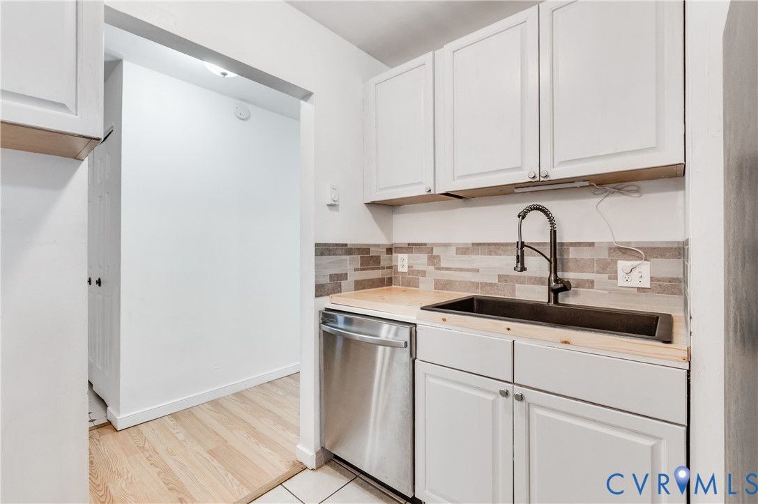 5724 Linda Road Sandston, VA 23150 - Photo 18 of 35 a kitchen with white cabinets sink and window