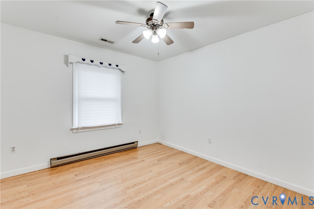 5724 Linda Road Sandston, VA 23150 - Photo 22 of 35 an empty room with a window and a ceiling fan