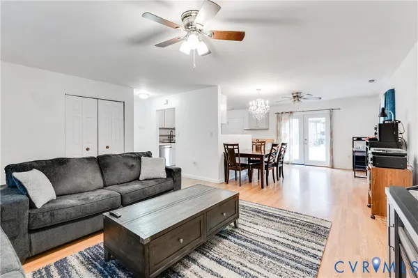 a living room with furniture and kitchen view