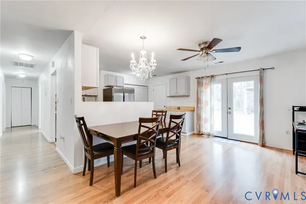 a view of a dining room with furniture and wooden floor