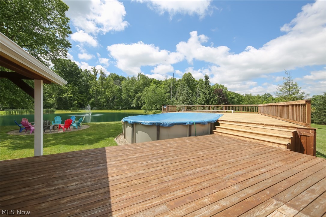 3362 Granger Road Medina, OH 44256 - Photo 37 of 49 Wooden terrace with a water view, a covered pool, and a yard