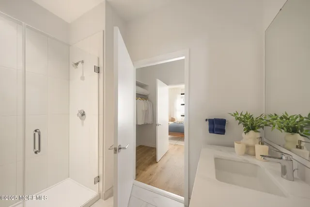 a bathroom with a shower and a sink