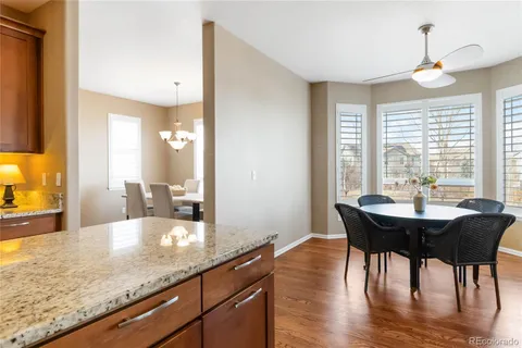 a view of a kitchen area with furniture and wooden floor