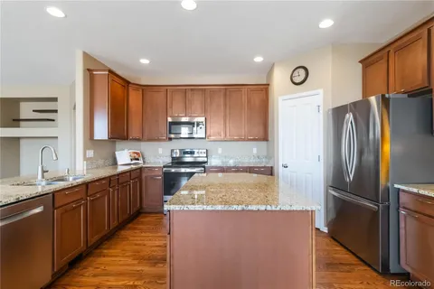 a view of a kitchen with a sink refrigerator and cabinets