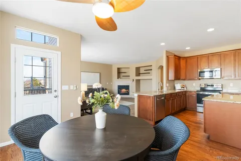 a dining room with furniture and wooden floor