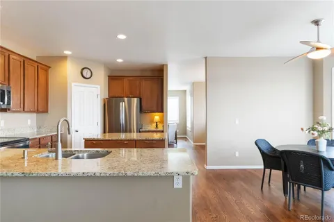 a kitchen with granite countertop a sink and cabinets
