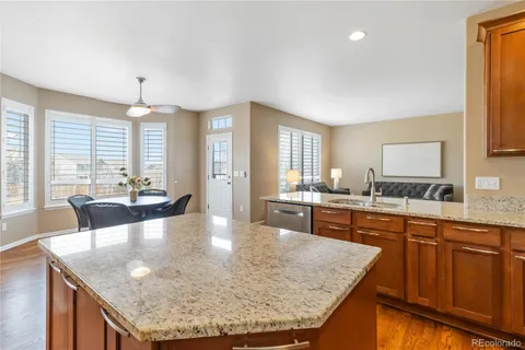a large kitchen with kitchen island a large counter top space a sink stainless steel appliances and cabinets