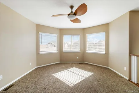 a view of workspace with window and a ceiling fan