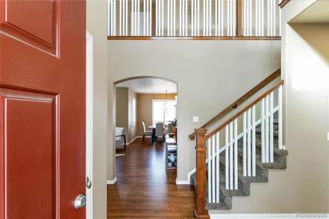 a view of an entryway with wooden floor and a livingroom