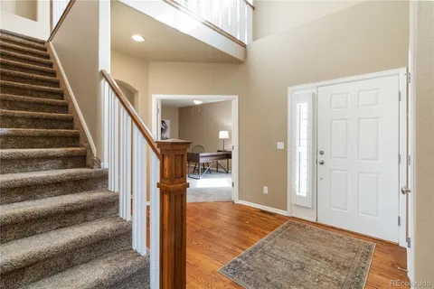 a view of entryway and hall with wooden floor