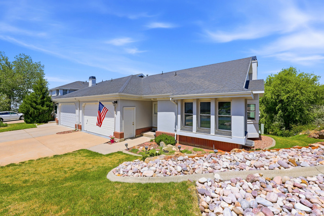 3766 Cardiff Circle Bountiful, UT 84010 - Photo 41 of 46 Contemporary exterior with a two-car garage, concrete driveway, multiple windows, and a rock-lined garden bed
