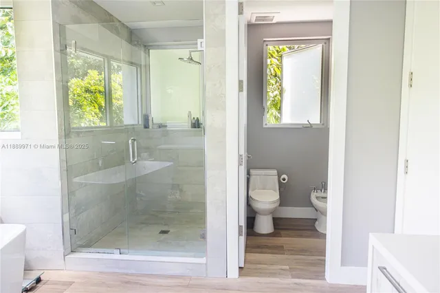 a bathroom with a shower and toilet