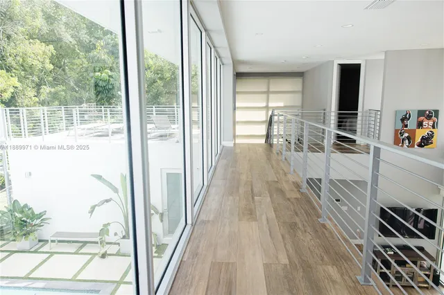 a view of a room with wooden floor