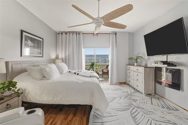 a bedroom with a bed and large window