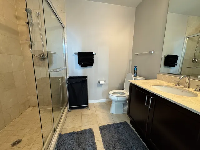 a spacious bathroom with a sink toilet and shower