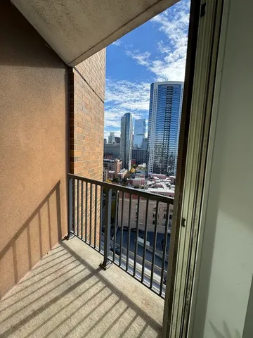 a view of staircase with a large window and wooden floor