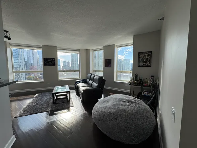 a living room with furniture window and wooden floor