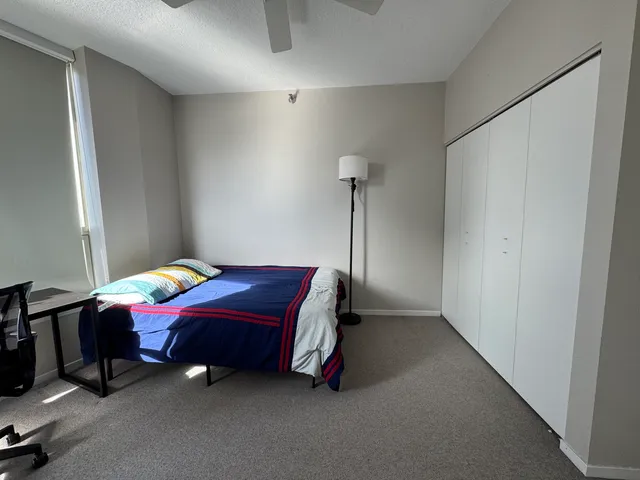 a bedroom with a bed and a table in it